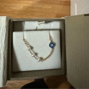 Gold pearl evil eye bracelet